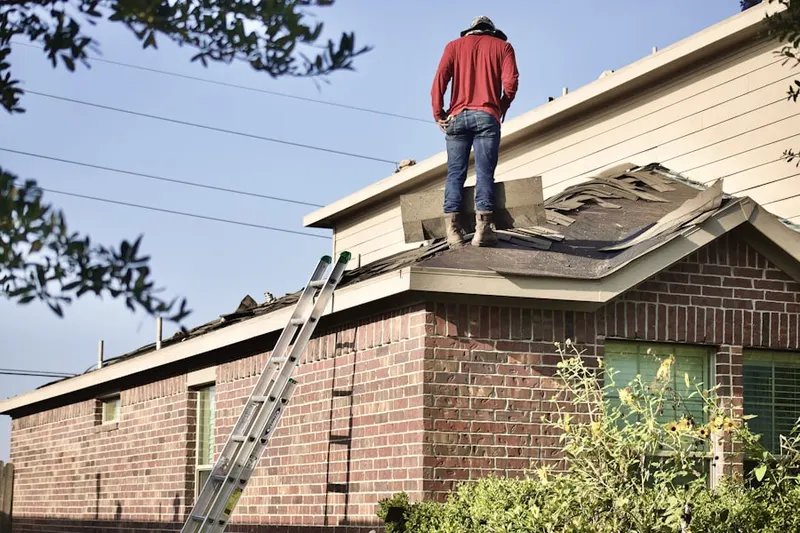 Professional roofer working on a residential roof in Wade